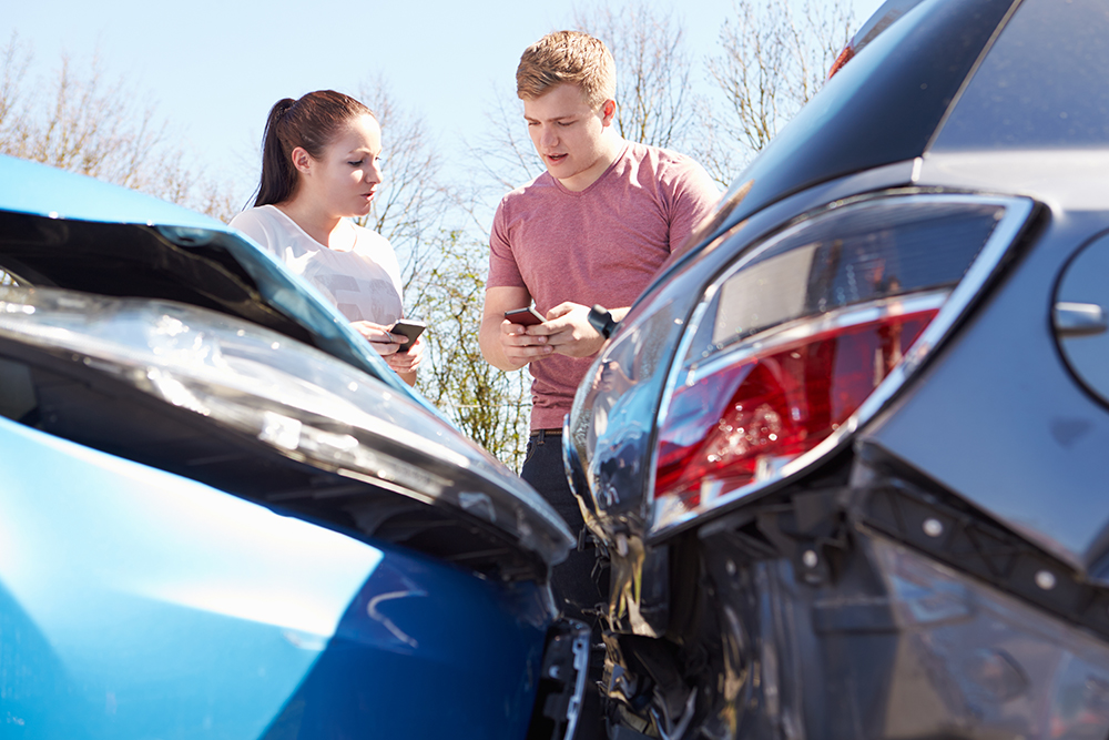 two people exchanging numbers after being in a collision