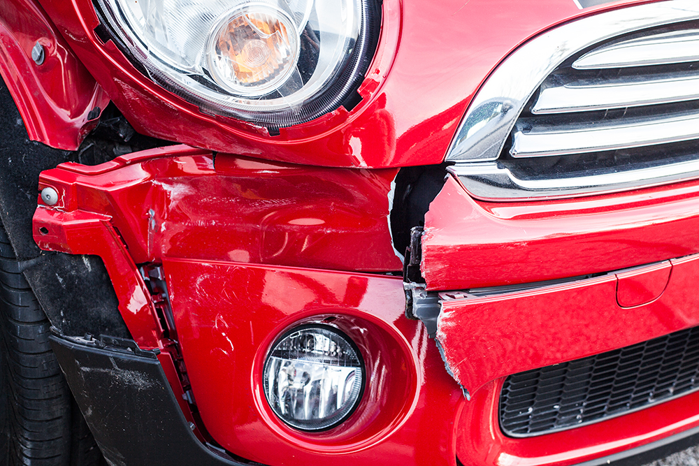 red car with damaged front bumper