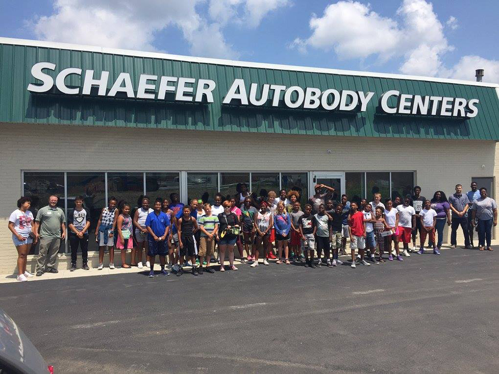 group of kids standing outside schaefer autobody centers location