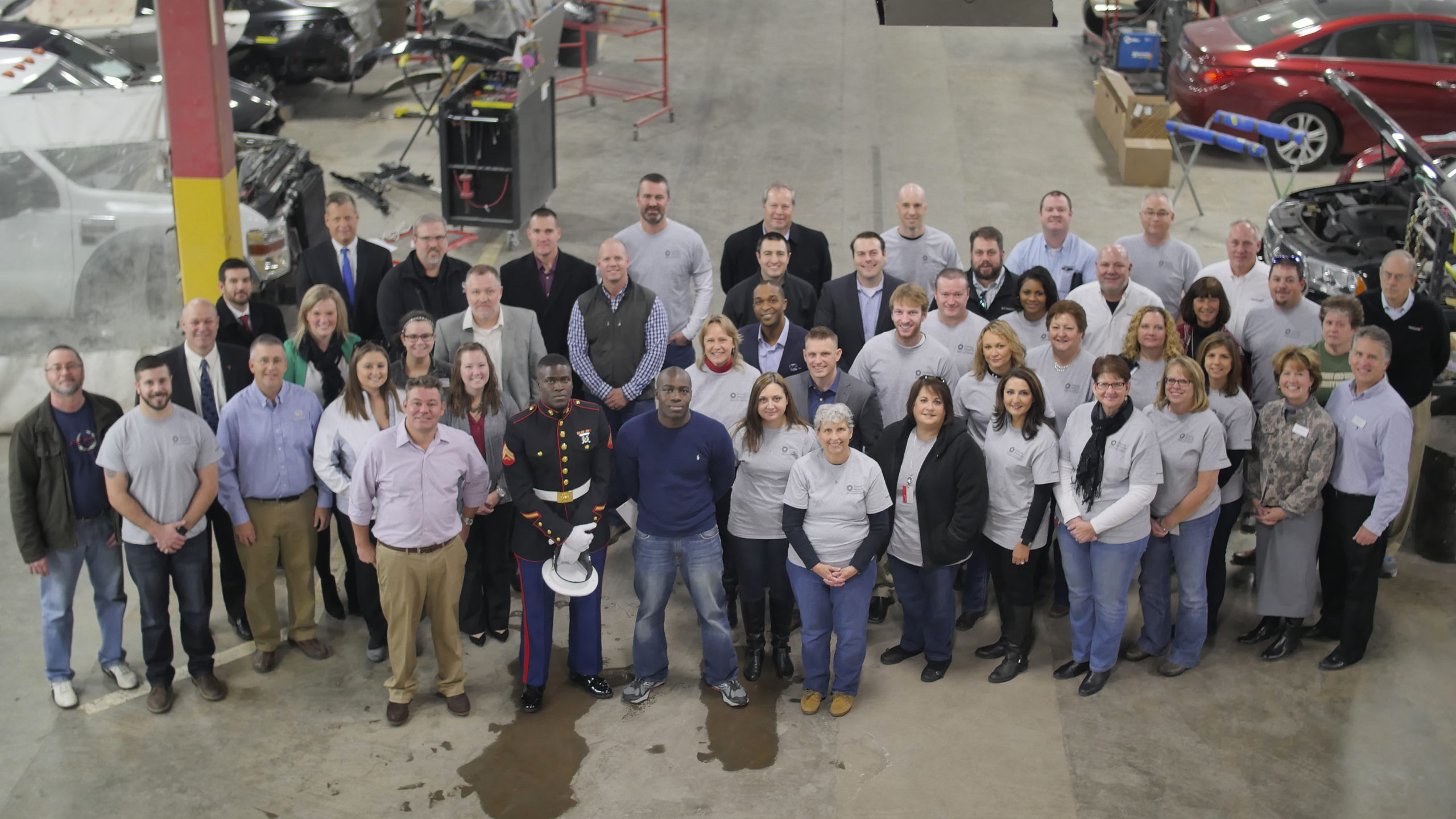| Schaefer Autobody Centers overhead group photo of people in repair shop