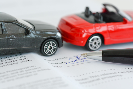 | Schaefer Autobody Centers Insurance policy contract concept with toy model cars having a crash or accident