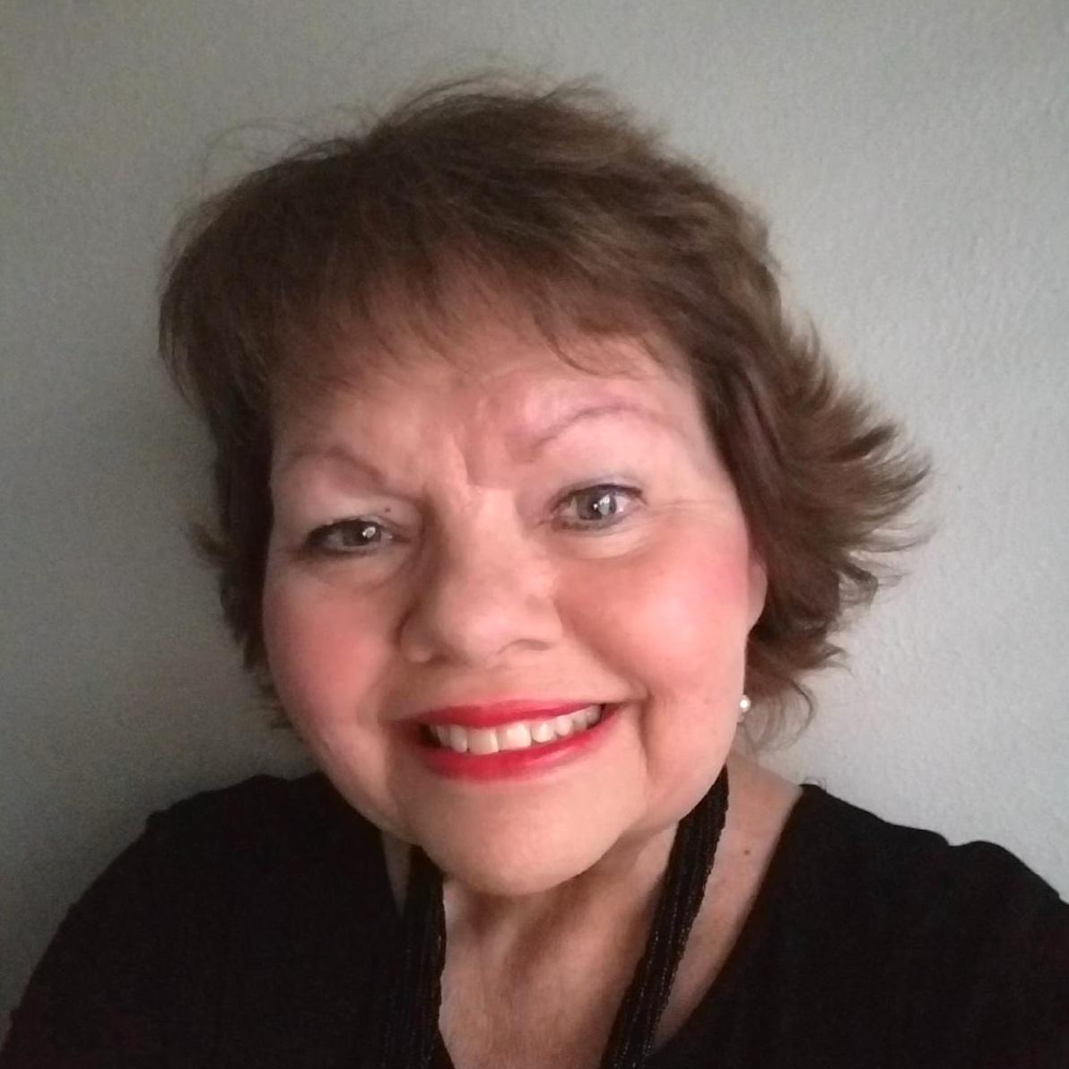 | Schaefer Autobody Centers jayne smiling in front of white wall