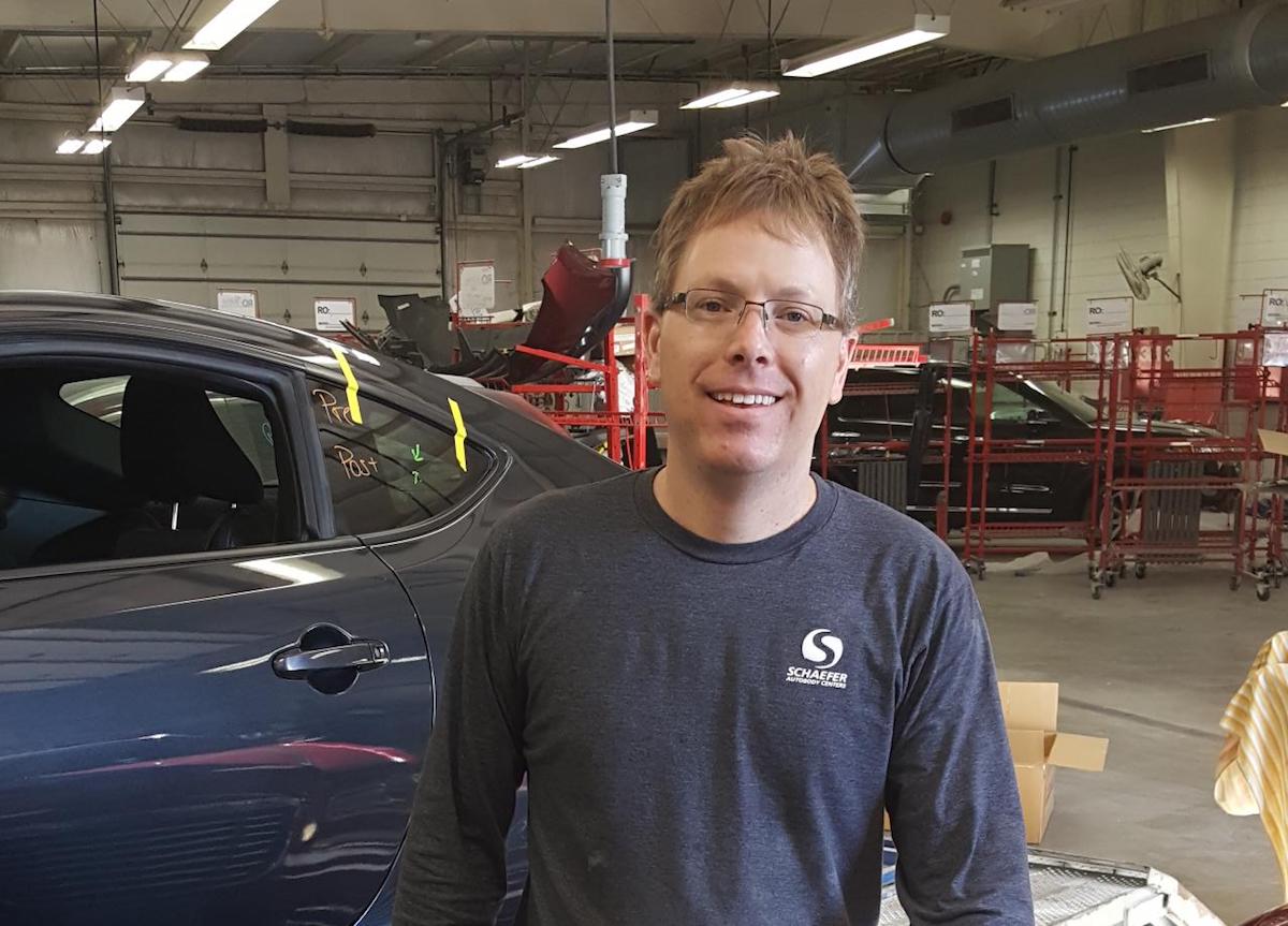 | Schaefer Autobody Centers chris standing in front of vehicle in repair shop