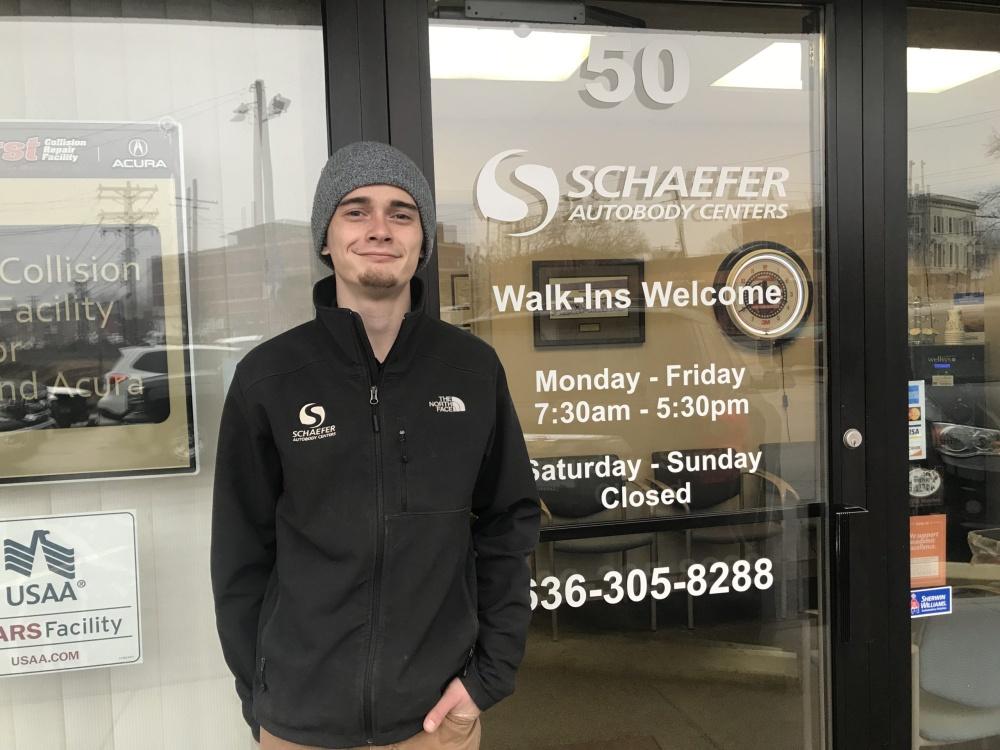 austin stands in front of schaefer autobody centers