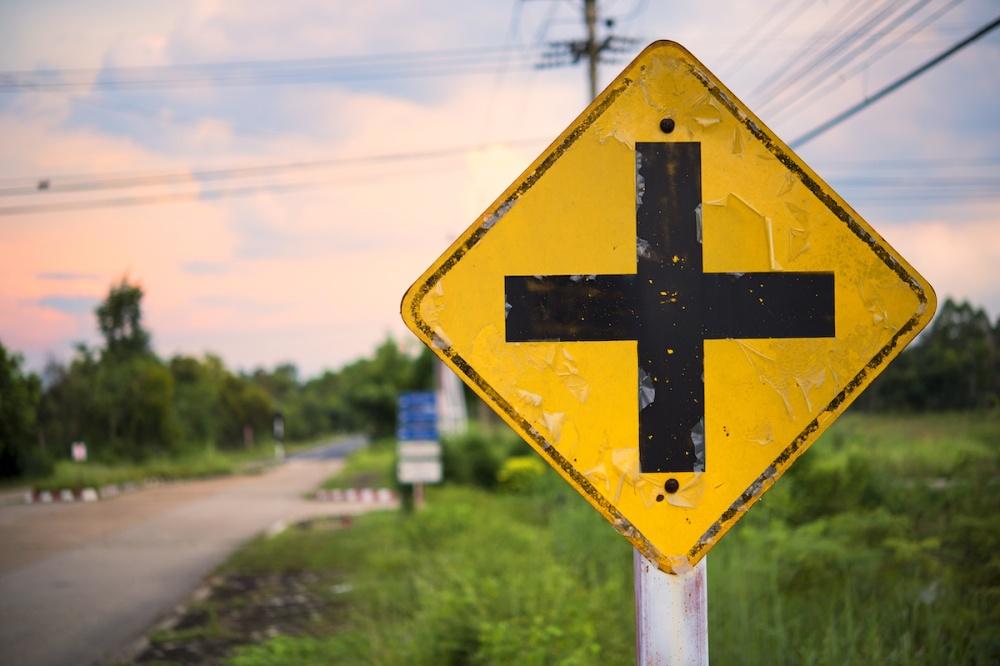 | Schaefer Autobody Centers Crossroads Sign: A road sign warns of an intersection ahead.