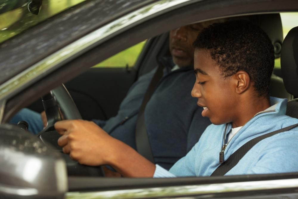 Father teaching his son how to drive.