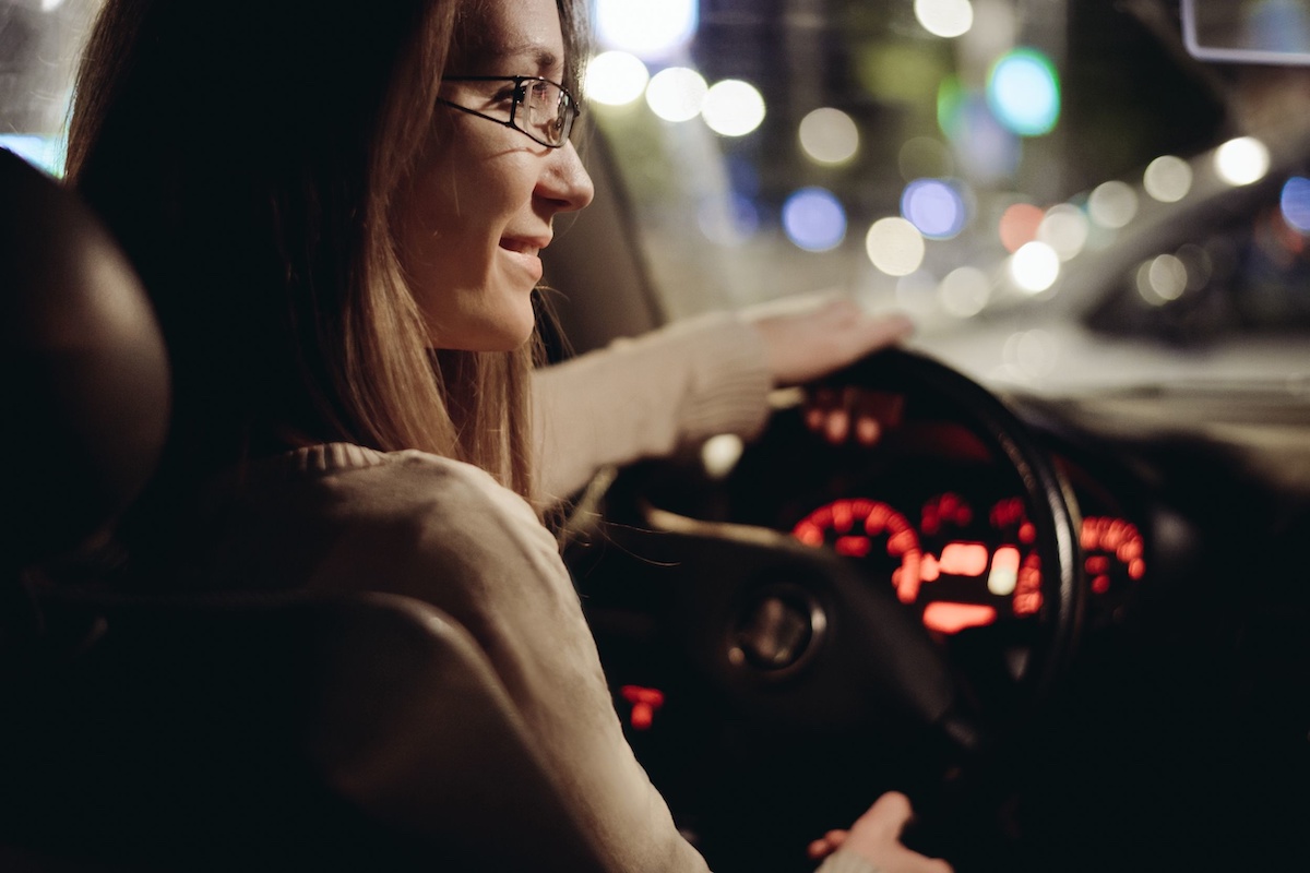 | Schaefer Autobody Centers woman driving car by night in the city