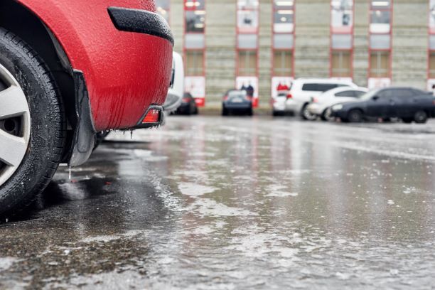 car parked in icy parking lot