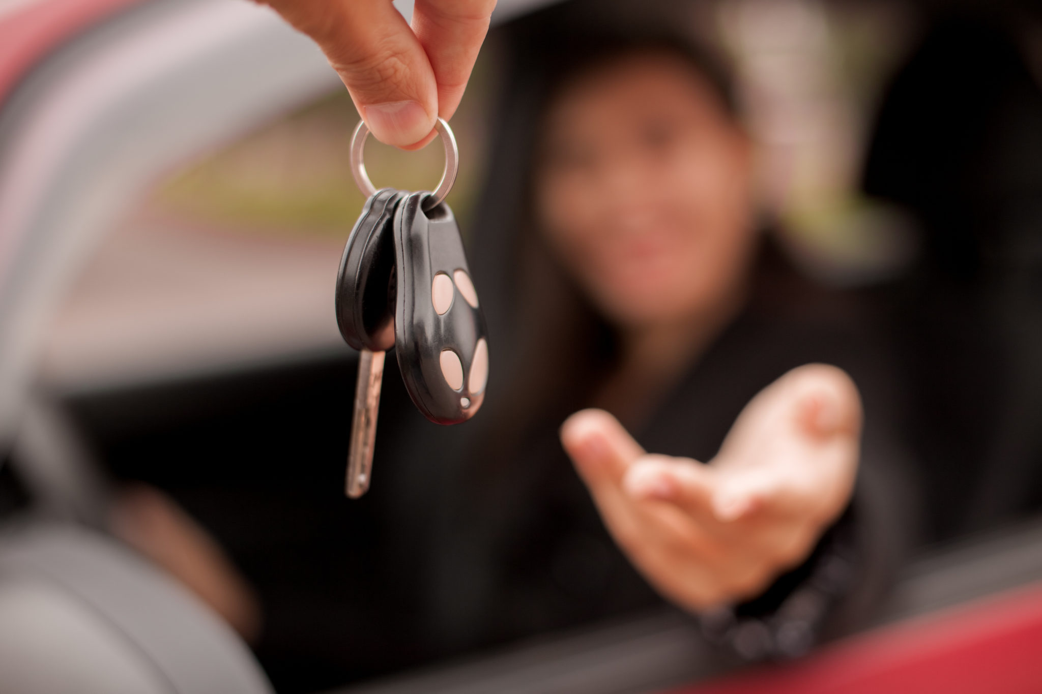 showroom dealer gives car keys to the buyer