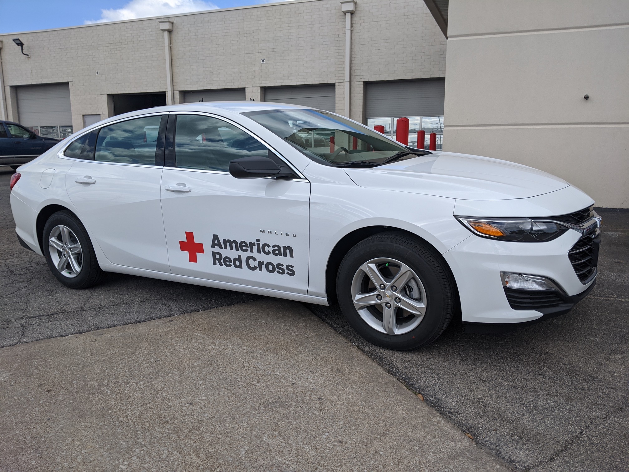 White car with American Red Cross logo on the side