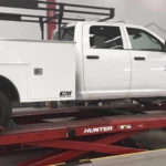 http://Fleet%20vehicle%20up%20on%20a%20scissor%20lift%20to%20be%20serviced.