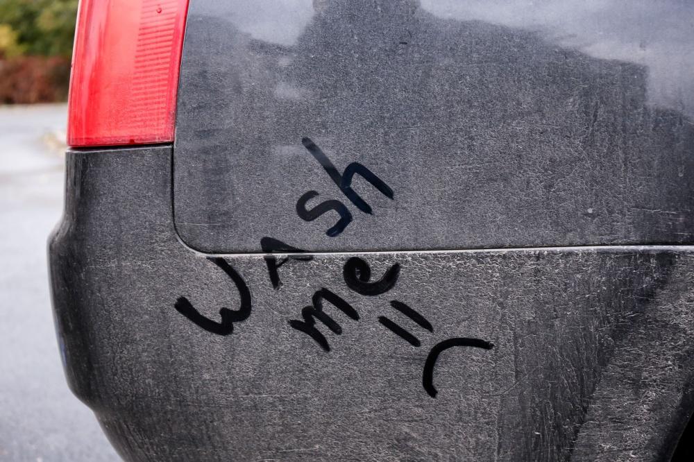 AdobeStock_183637898 | Schaefer Autobody Centers dirty car with "wash me" written in the grime