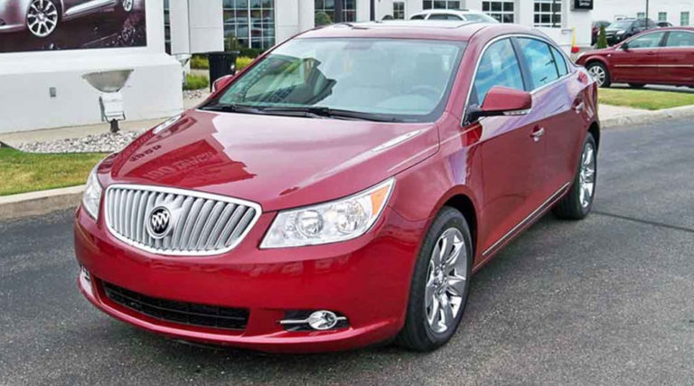 After shot of a red Buick that had sustained major damage to the driver's side.