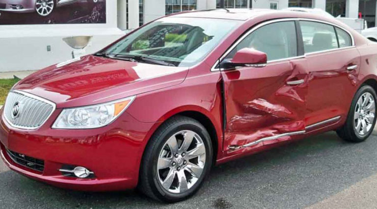 Before shot of a red Buick that had sustained major damage to the driver's side.