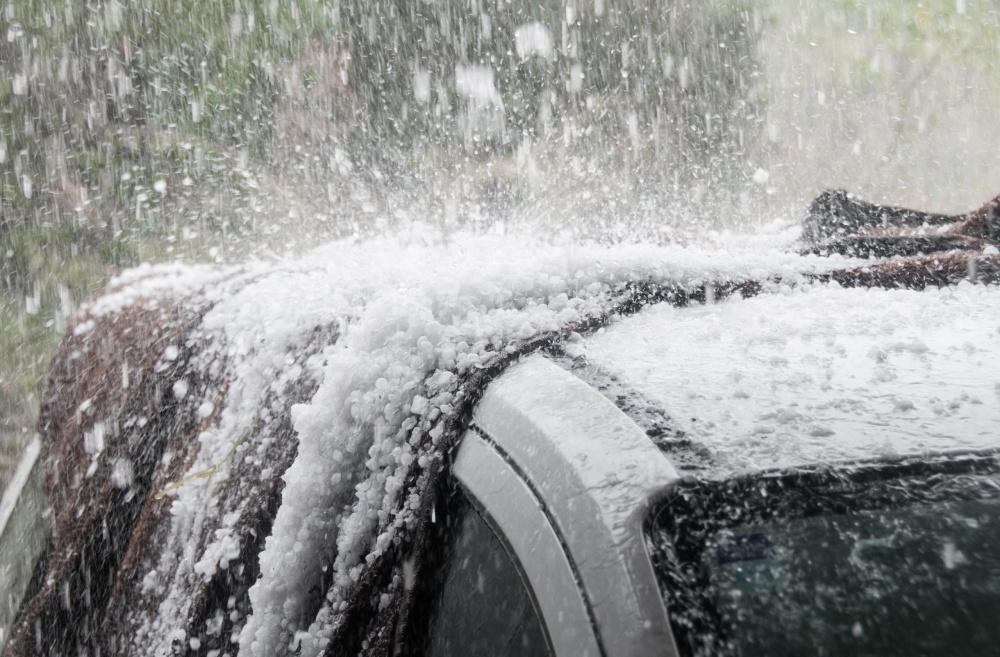 Car roof being hammered by heavy hail storm