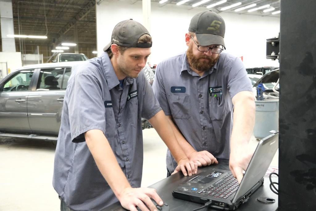 two technicians working at a computer