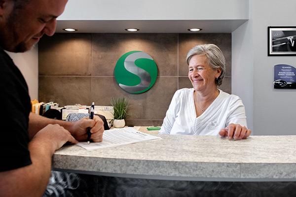 Front desk receptionist helps a customer